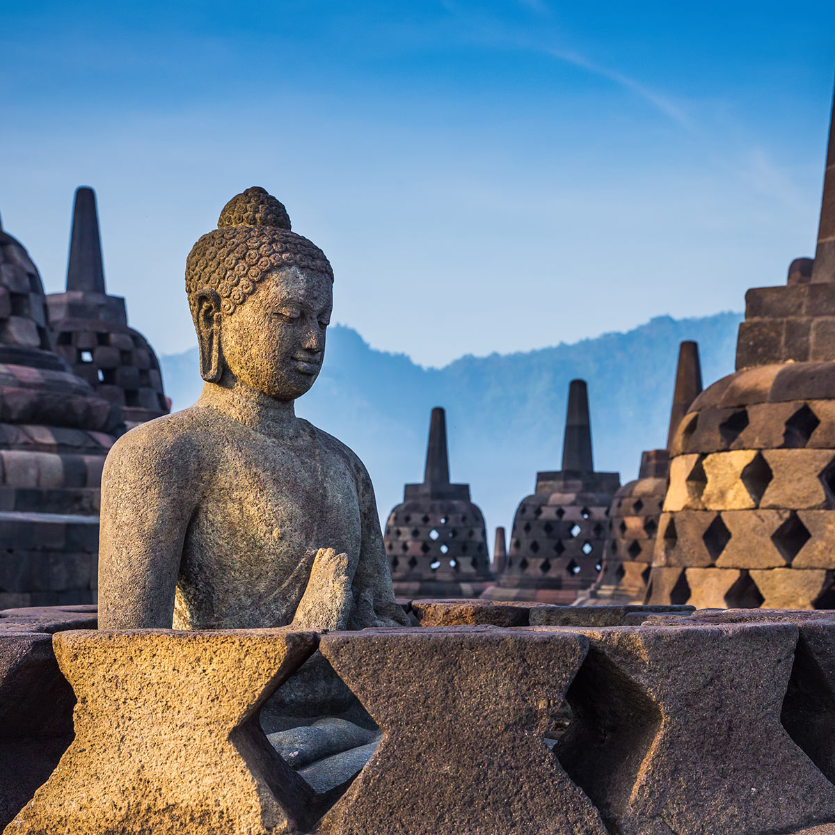 Ancient Buddha statue and stupa at Borobudur temple in Yogyakarta, Java, Indonesia