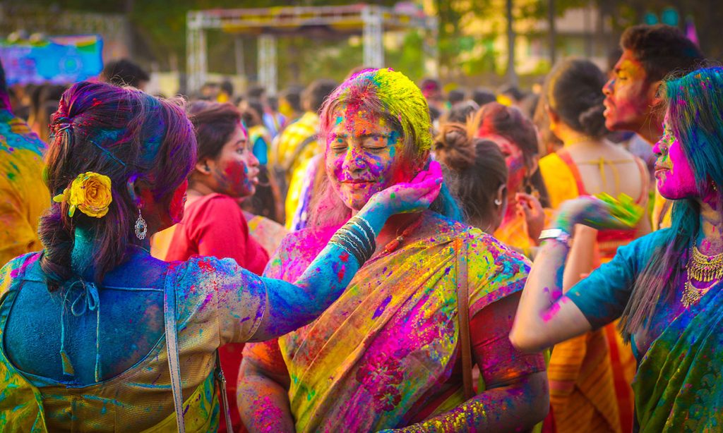 Friends with coloured dyes during Holi in Kolkata, India